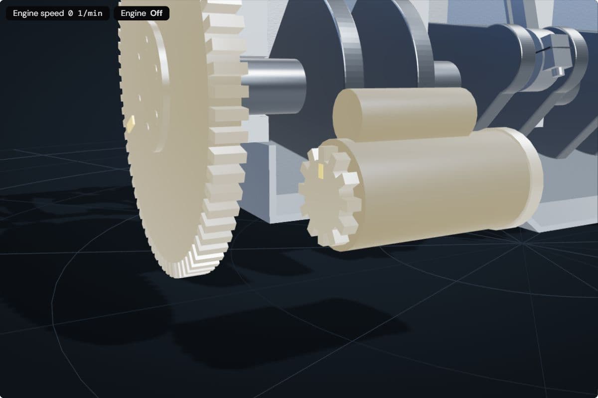 Close-up of the starter's 12-tooth pinion next to the flywheel's 72-tooth ring gear, the engine still off